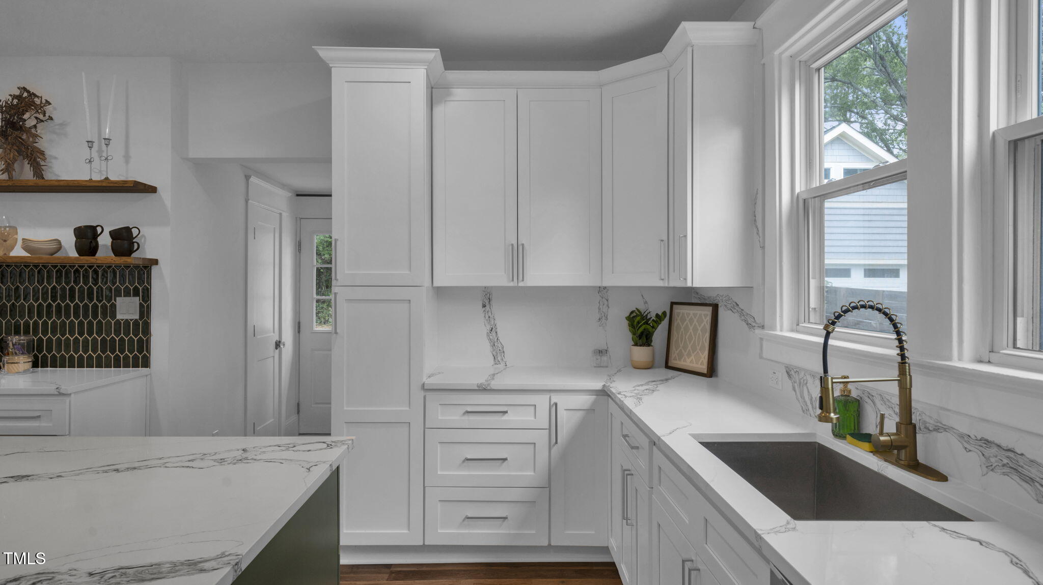 1307 Wake Forest Road Raleigh, NC 27604 - Photo 14 of 51 a kitchen with granite countertop a sink a stove and cabinets