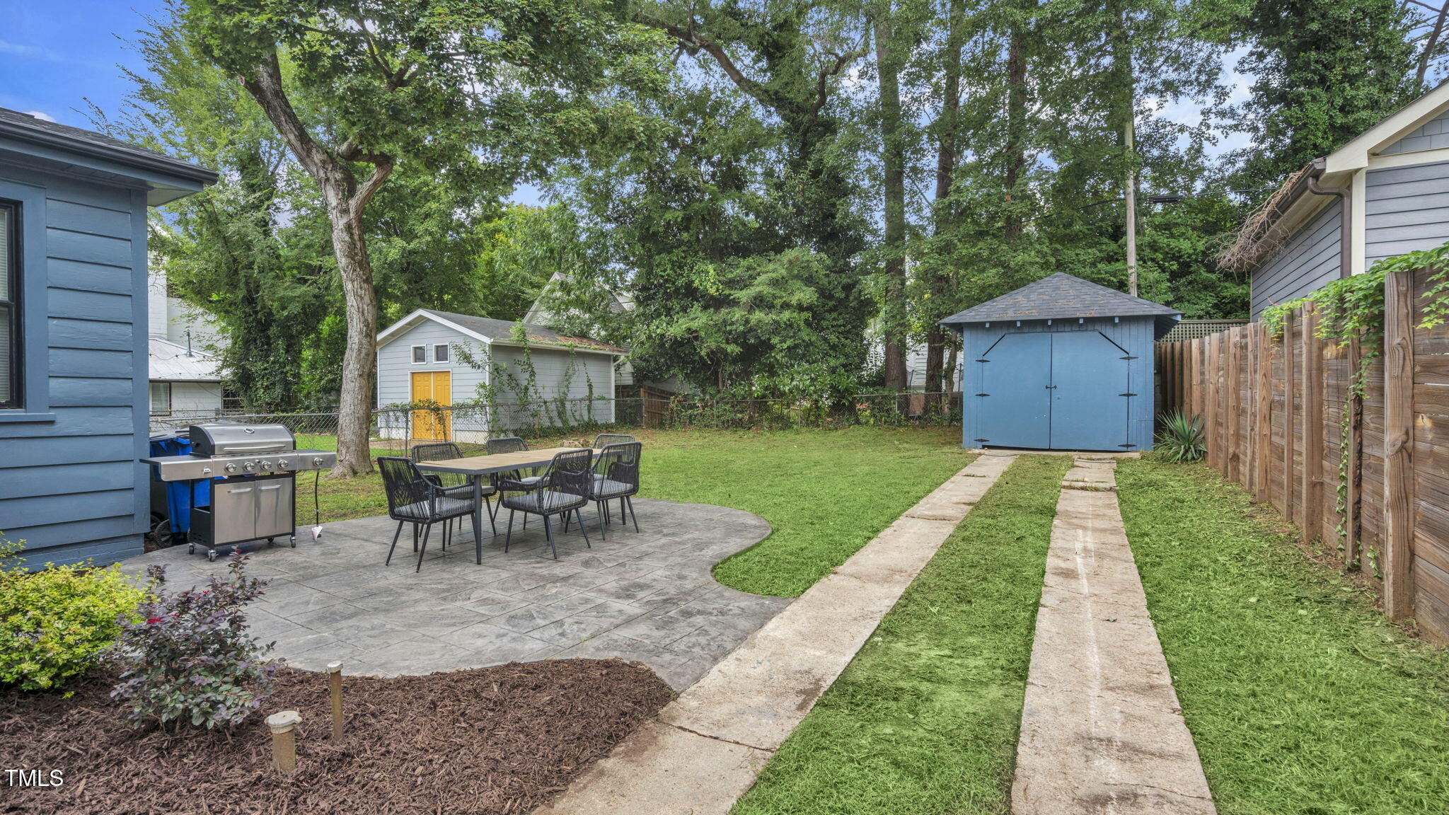 1307 Wake Forest Road Raleigh, NC 27604 - Photo 49 of 51 a view of a backyard with table and chairs and a small yard