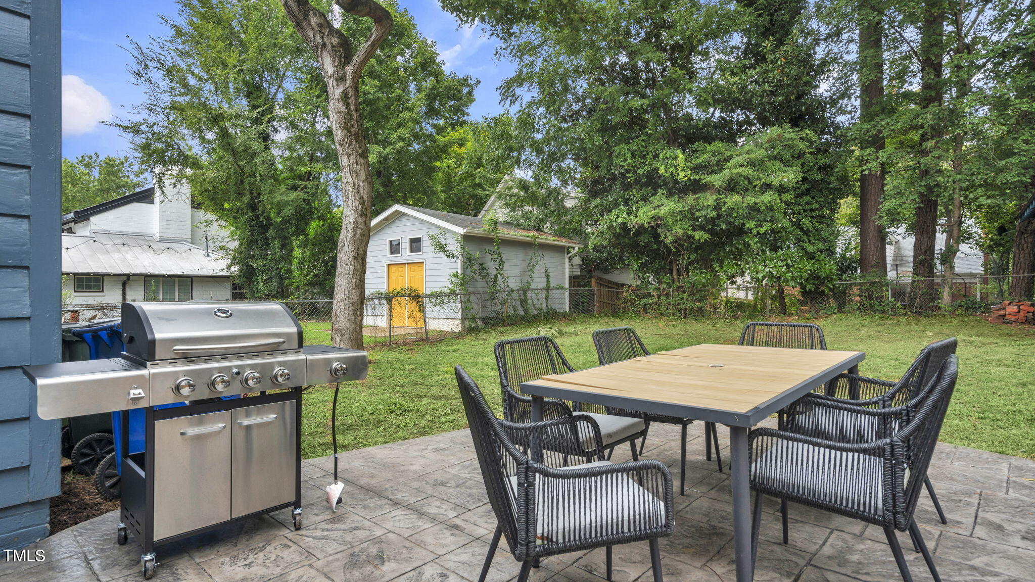 1307 Wake Forest Road Raleigh, NC 27604 - Photo 50 of 51 a view of a chairs and table in the back yard of the house