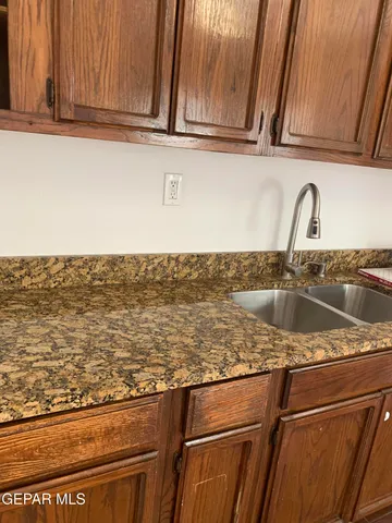a kitchen with wooden cabinets and a stove top oven