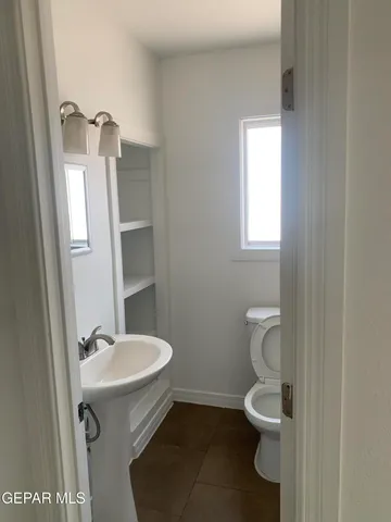 a view of a big room with a ceiling fan