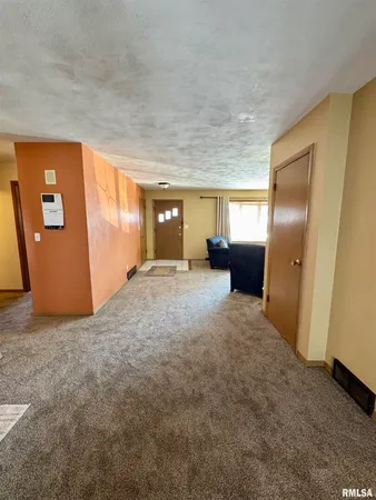 an empty room with closet and mirror