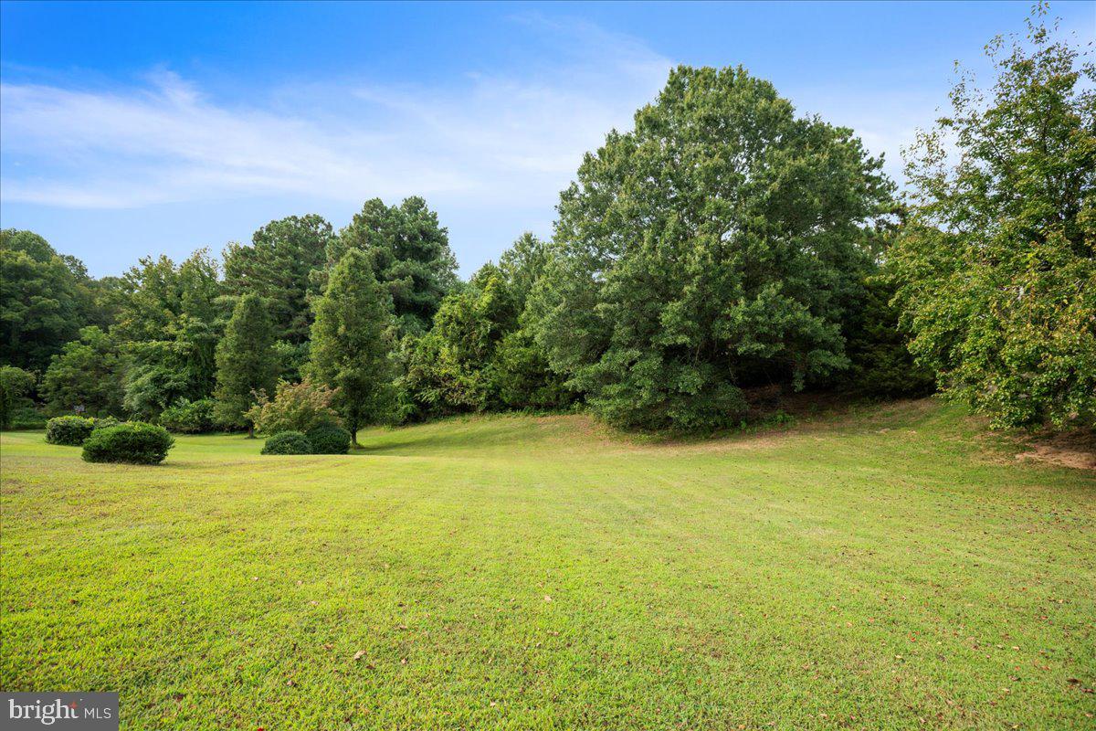 694 Ponds Wood Road Huntingtown, MD 20639 - Photo 54 of 58 a view of a large pool with an outdoor space and seating area