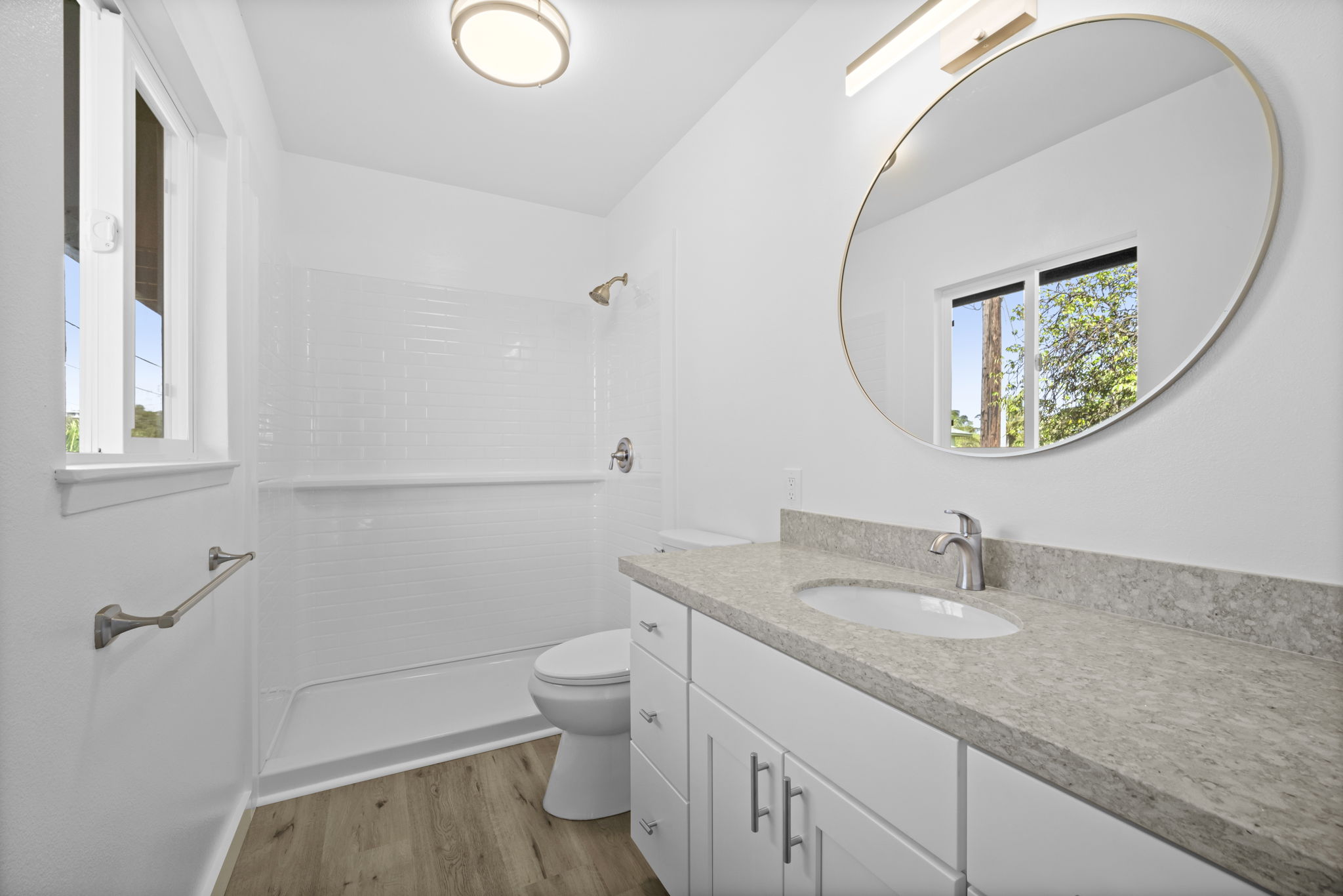4431 Iona Road Hanapepe, HI 96705 - Photo 17 of 20 a bathroom with a granite countertop sink a toilet and a mirror