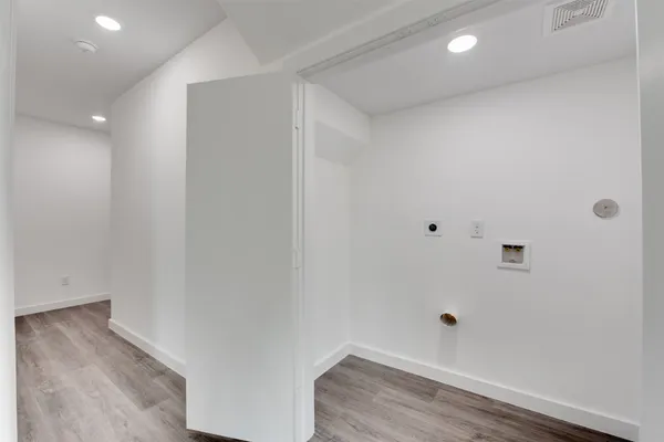 a view of room with wooden floor