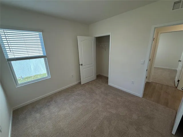 a view of a kitchen with wooden floor and electronic appliances