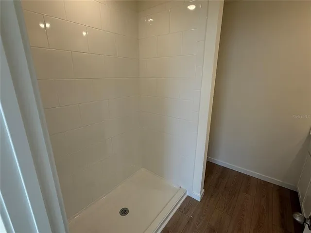 a bathroom with a granite countertop toilet and a shower