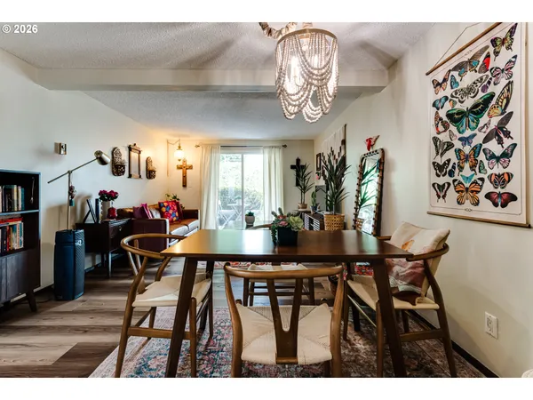 a view of a dining room with furniture and a chandelier
