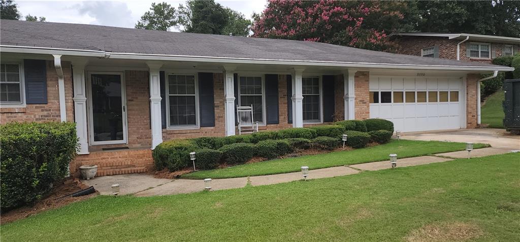 a view of a house with a yard and plants