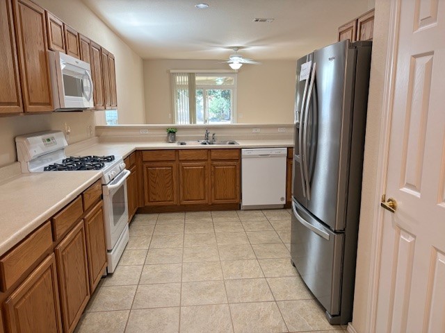 318 Crockett Loop Georgetown, TX 78633 - Photo 11 of 29 a kitchen with stainless steel appliances granite countertop a refrigerator and a sink