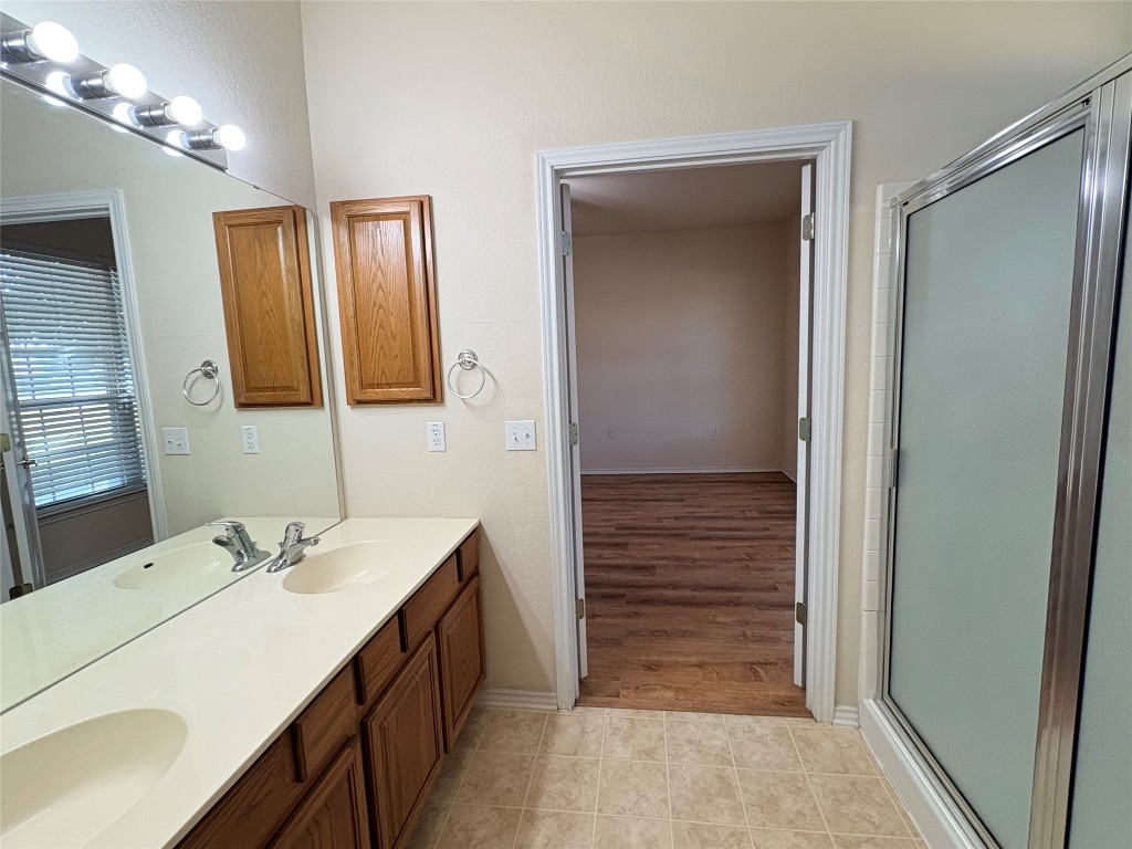 318 Crockett Loop Georgetown, TX 78633 - Photo 17 of 29 a bathroom with a sink a vanity and a mirror