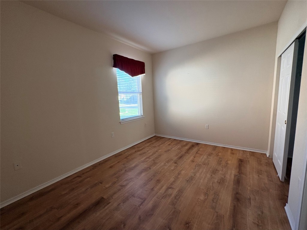 318 Crockett Loop Georgetown, TX 78633 - Photo 21 of 29 an empty room with wooden floor and windows