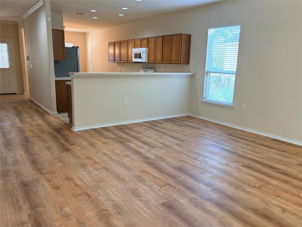318 Crockett Loop Georgetown, TX 78633 - Photo 3 of 29 a view of kitchen with wooden floor and electronic appliances