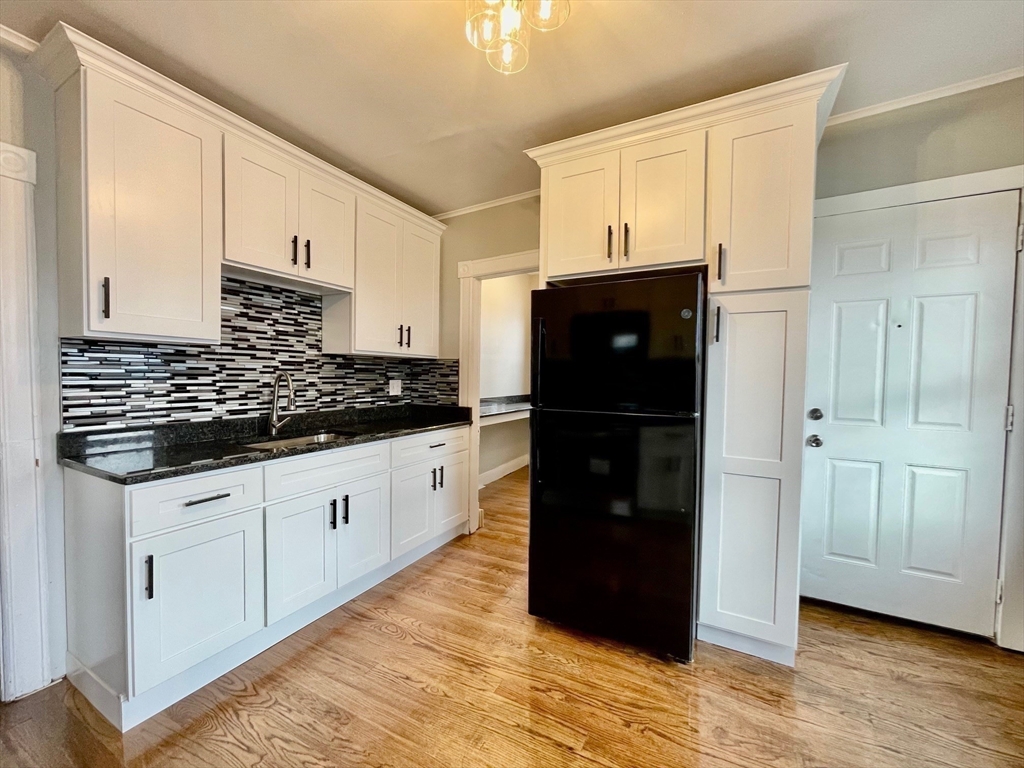119 Revere Street, Unit 3 Springfield, MA 01108 - Photo 11 of 16 a kitchen with granite countertop a refrigerator and a stove