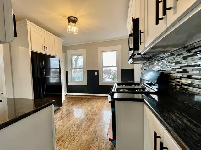 a kitchen with stainless steel appliances granite countertop a refrigerator stove and sink