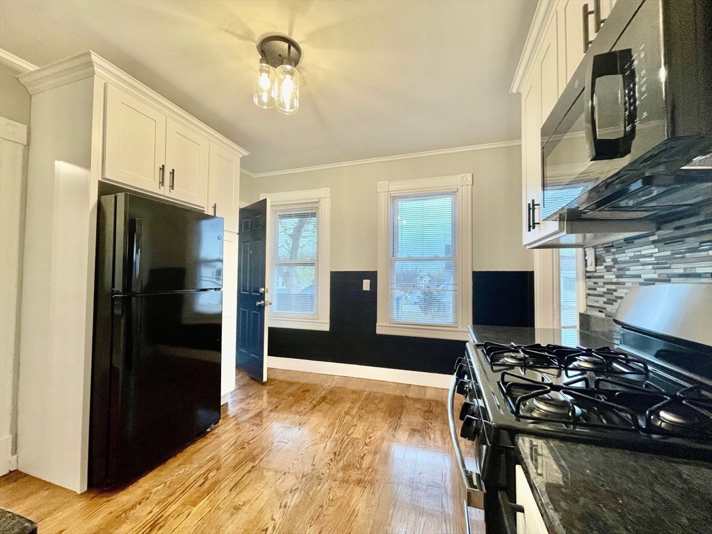119 Revere Street, Unit 3 Springfield, MA 01108 - Photo 2 of 16 a kitchen with stainless steel appliances granite countertop a refrigerator and a stove