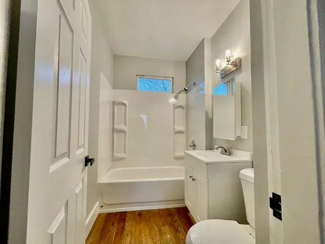 a bathroom with a tub toilet and shower