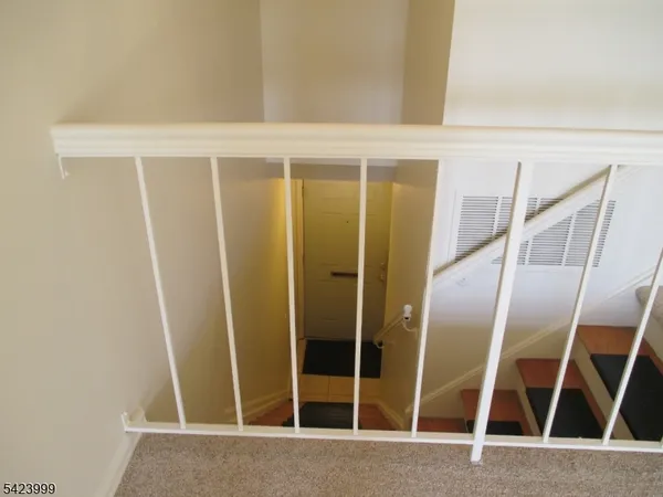 a view of closet with wooden floor