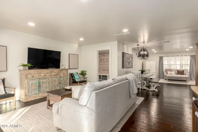 a living room with fireplace furniture and a flat screen tv