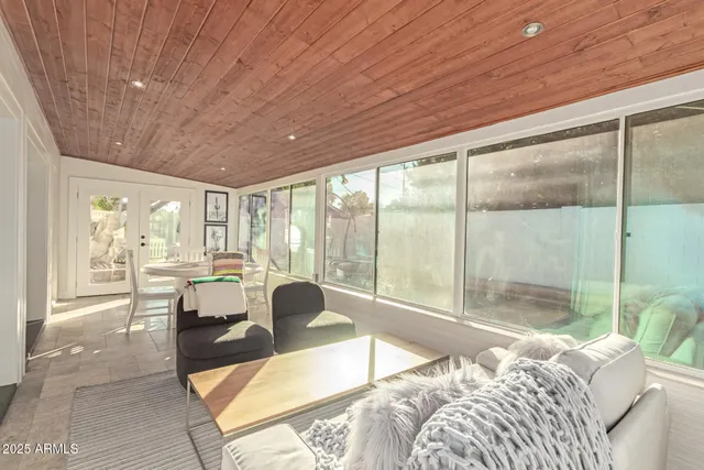 a bed room with a bed and a large window