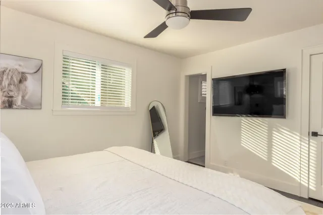 a bedroom with a bed and a flat screen tv