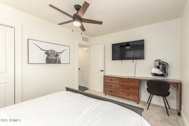 a bedroom with a bed and a flat screen tv