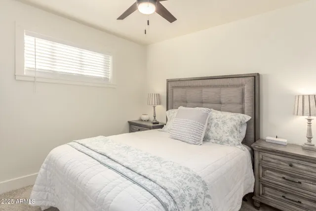 a bedroom with a large bed and a window