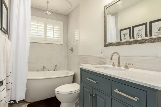 a bathroom with a toilet sink and mirror