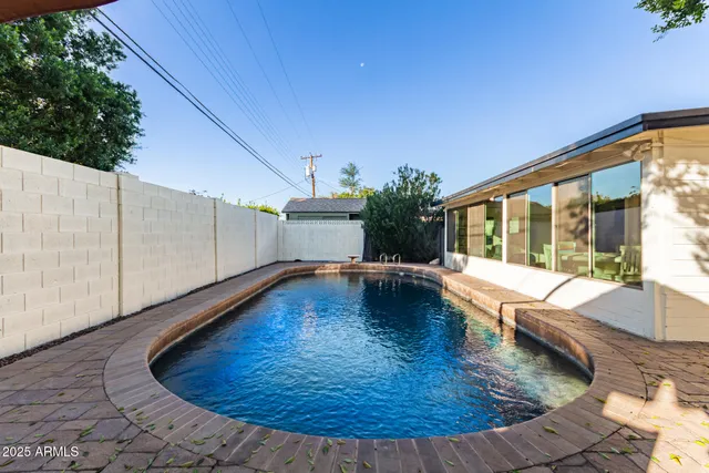 a view of swimming pool with seating space