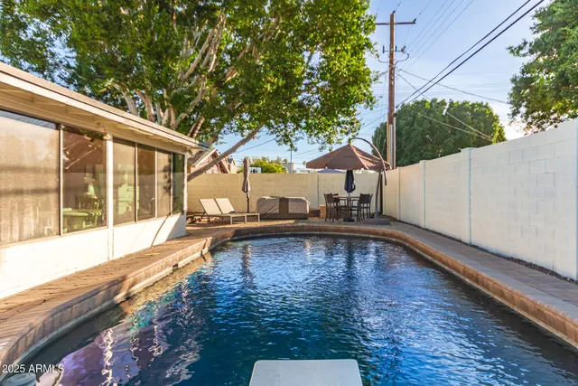 a view of a swimming pool with a patio