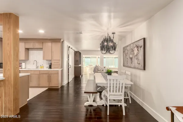 a view of a dining room with furniture wooden floor and chandelier