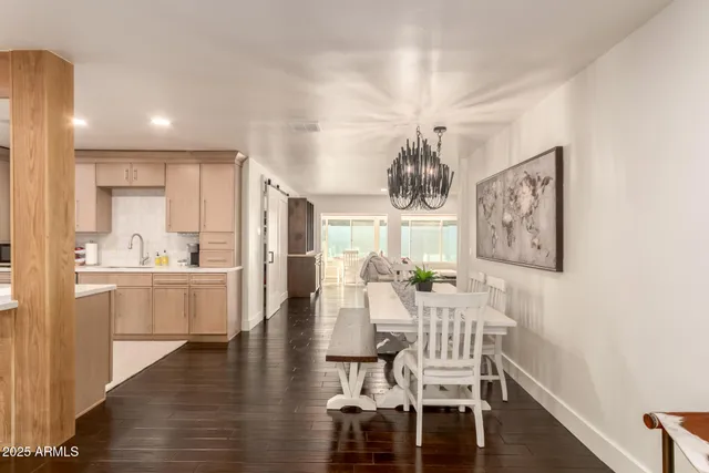 a view of a dining room with furniture wooden floor and chandelier
