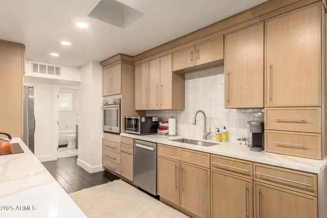 a kitchen with a sink cabinets and stainless steel appliances