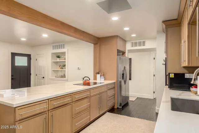 a spacious bathroom with a double vanity sink a large mirror and a shower