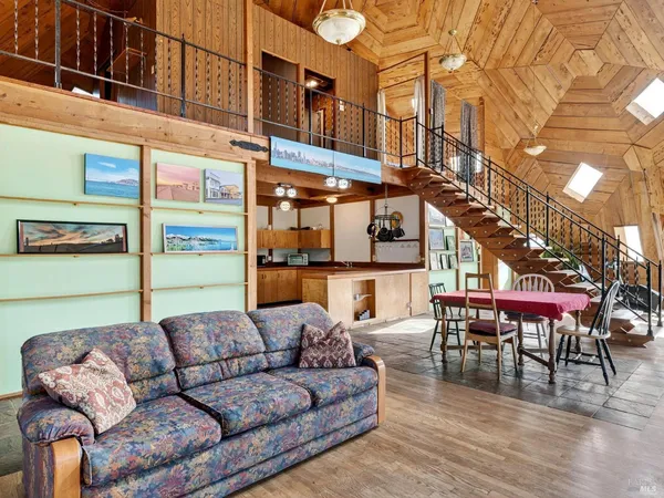 a view of a balcony with furniture and wooden floor