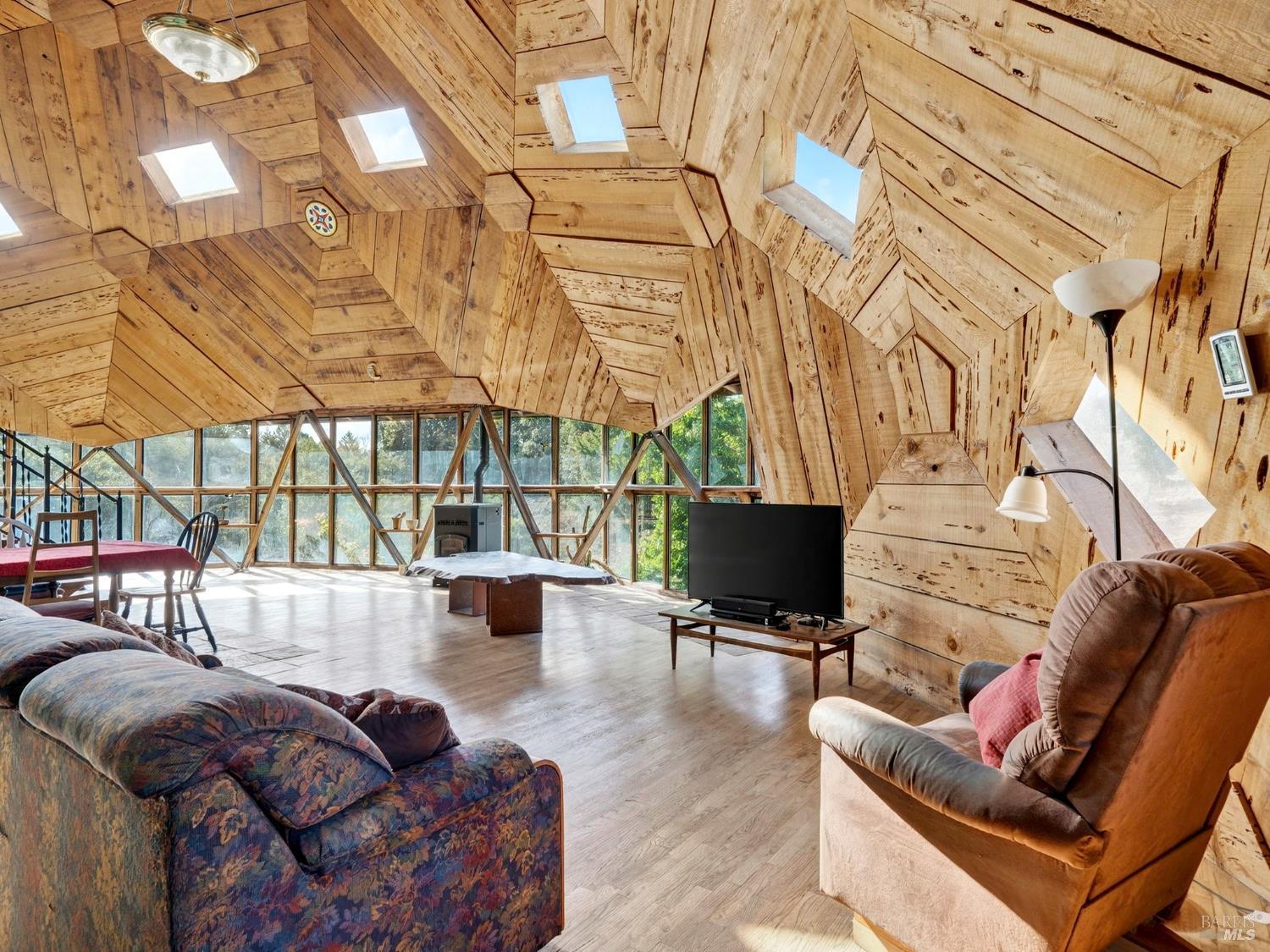 2333 Guntley Road Philo, CA 95466 - Photo 10 of 57 a living room with furniture a flat screen tv and a floor to ceiling window
