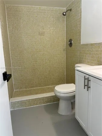 a bathroom with a toilet and shower