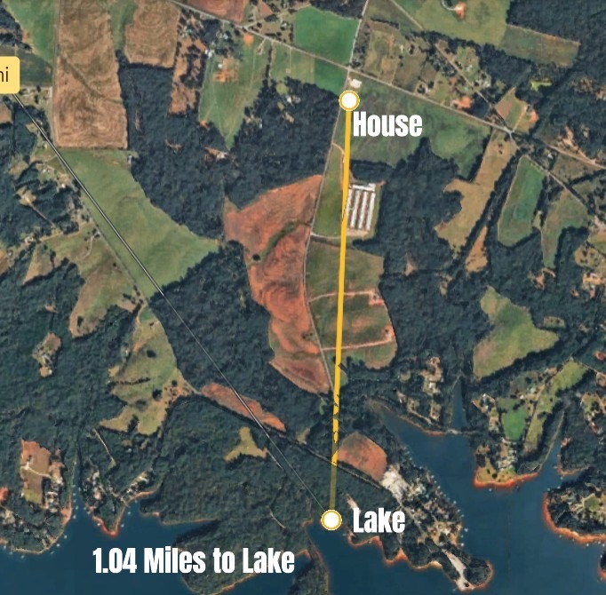 119 Dobbins Road Townville, SC 29689 - Photo 20 of 21 This aerial view showcases a residential property nestled amidst lush trees and fields, with convenient lake access.