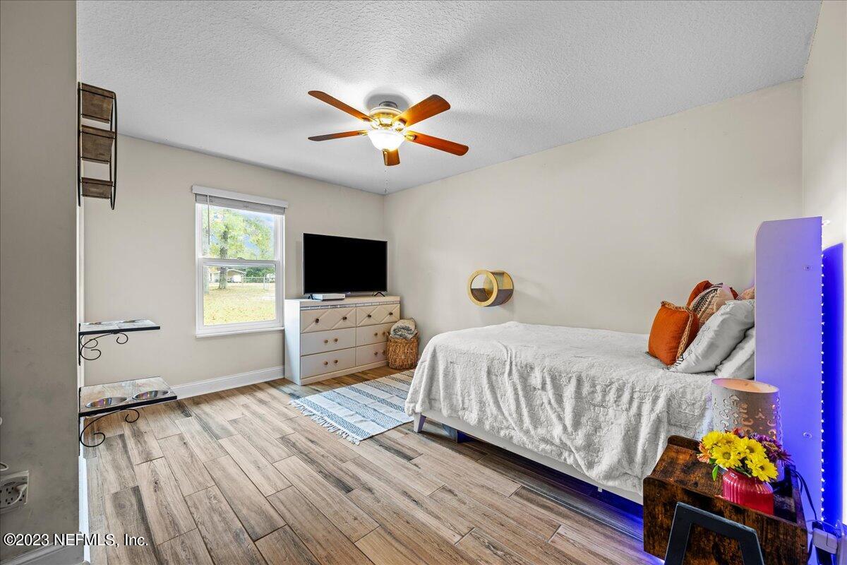 4755 Leopard Circle Middleburg, FL 32068 - Photo 17 of 38 a bedroom with a bed and a flat screen tv