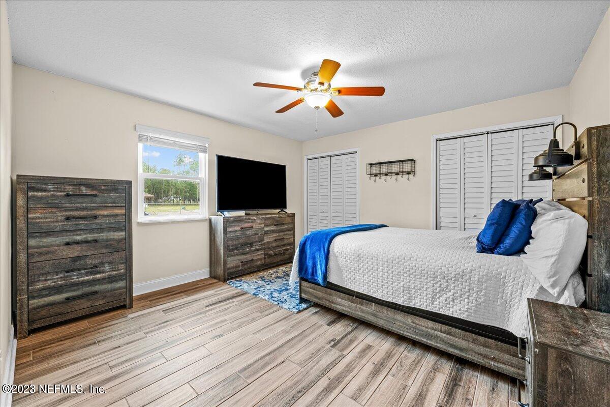 4755 Leopard Circle Middleburg, FL 32068 - Photo 19 of 38 a bedroom with a bed and a flat screen tv