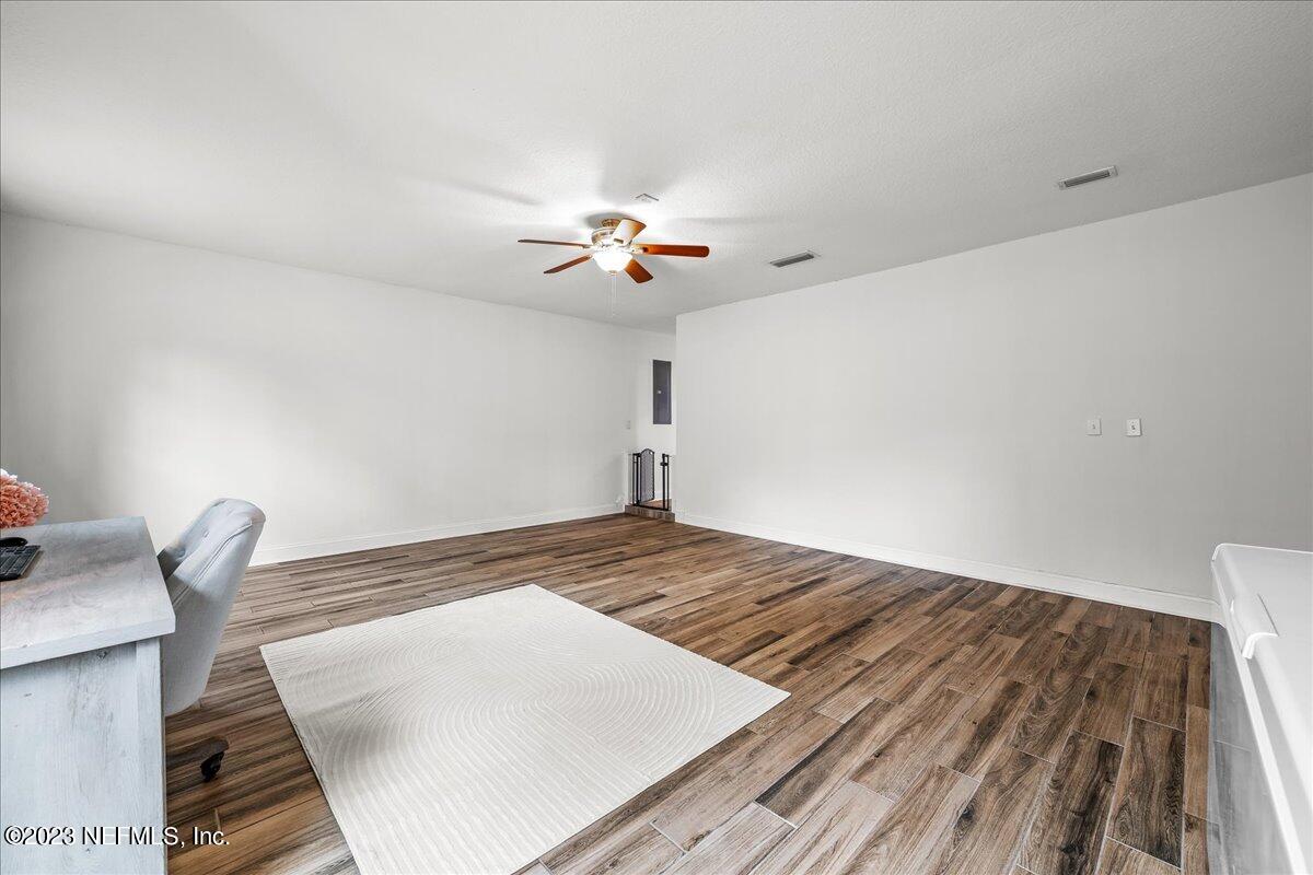 4755 Leopard Circle Middleburg, FL 32068 - Photo 21 of 38 a bedroom with a bed and a chandelier