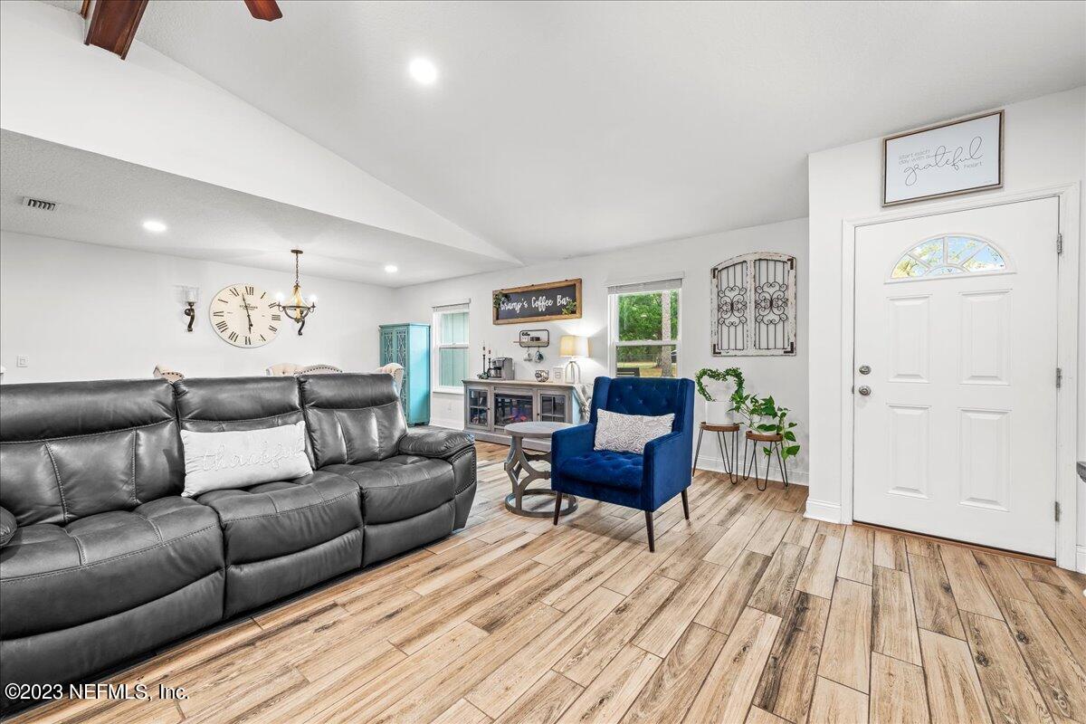 4755 Leopard Circle Middleburg, FL 32068 - Photo 4 of 38 a living room with furniture and a wooden floor