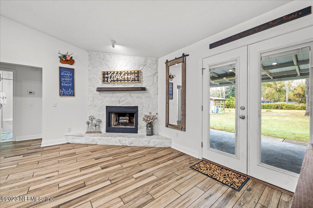 4755 Leopard Circle Middleburg, FL 32068 - Photo 6 of 38 a view of a livingroom with wooden floor and a fireplace