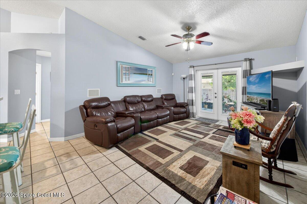 5975 Aruin Street Cocoa, FL 32927 - Photo 18 of 70 a living room with furniture and a chandelier