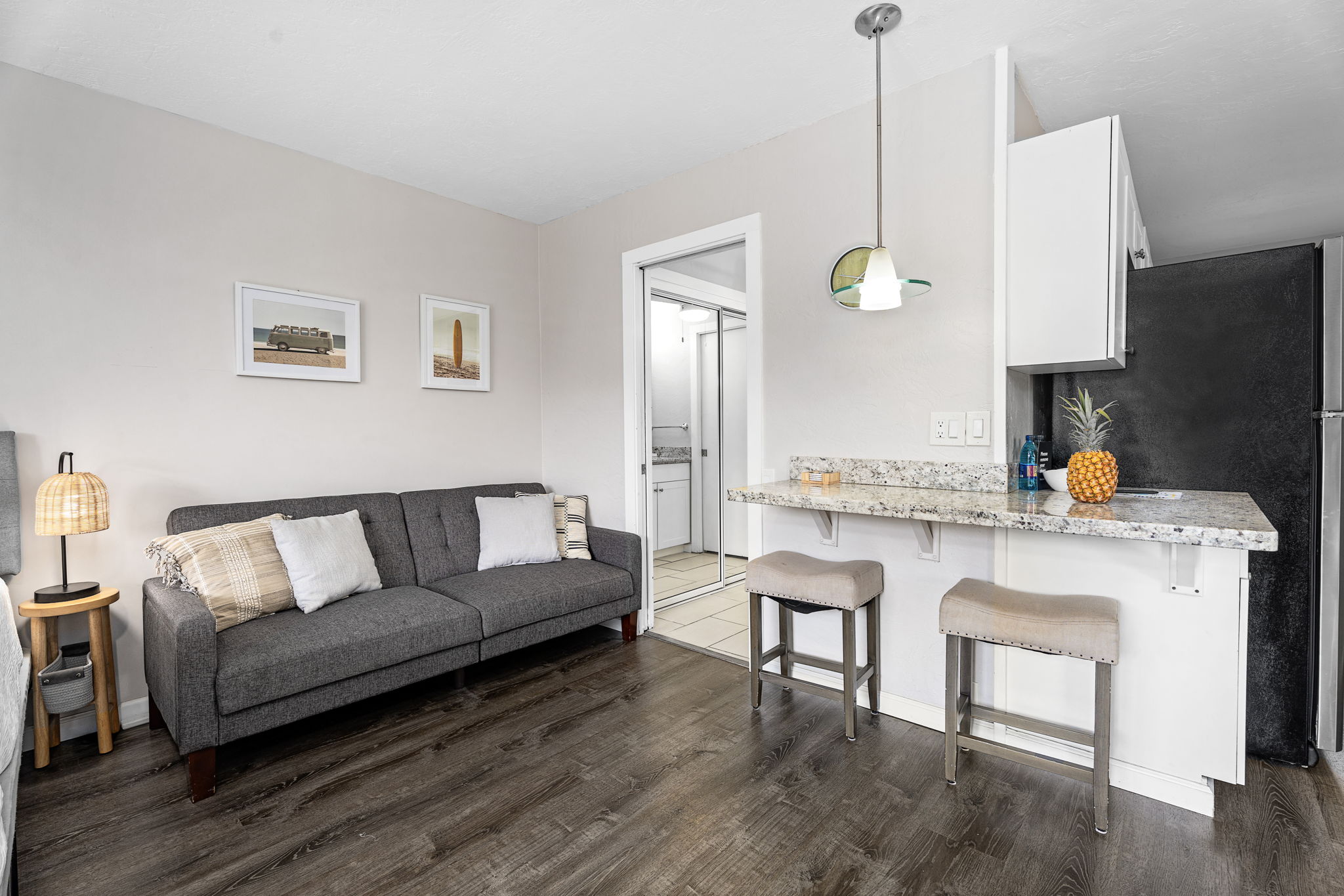 76-6233 Alii Drive, Unit 264 Kailua-Kona, HI 96740 - Photo 3 of 17 a living room with stainless steel appliances furniture a rug and a kitchen view