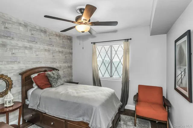 a bedroom with a bed a chair and a fireplace