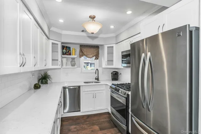 a kitchen with a sink stainless steel appliances and cabinets