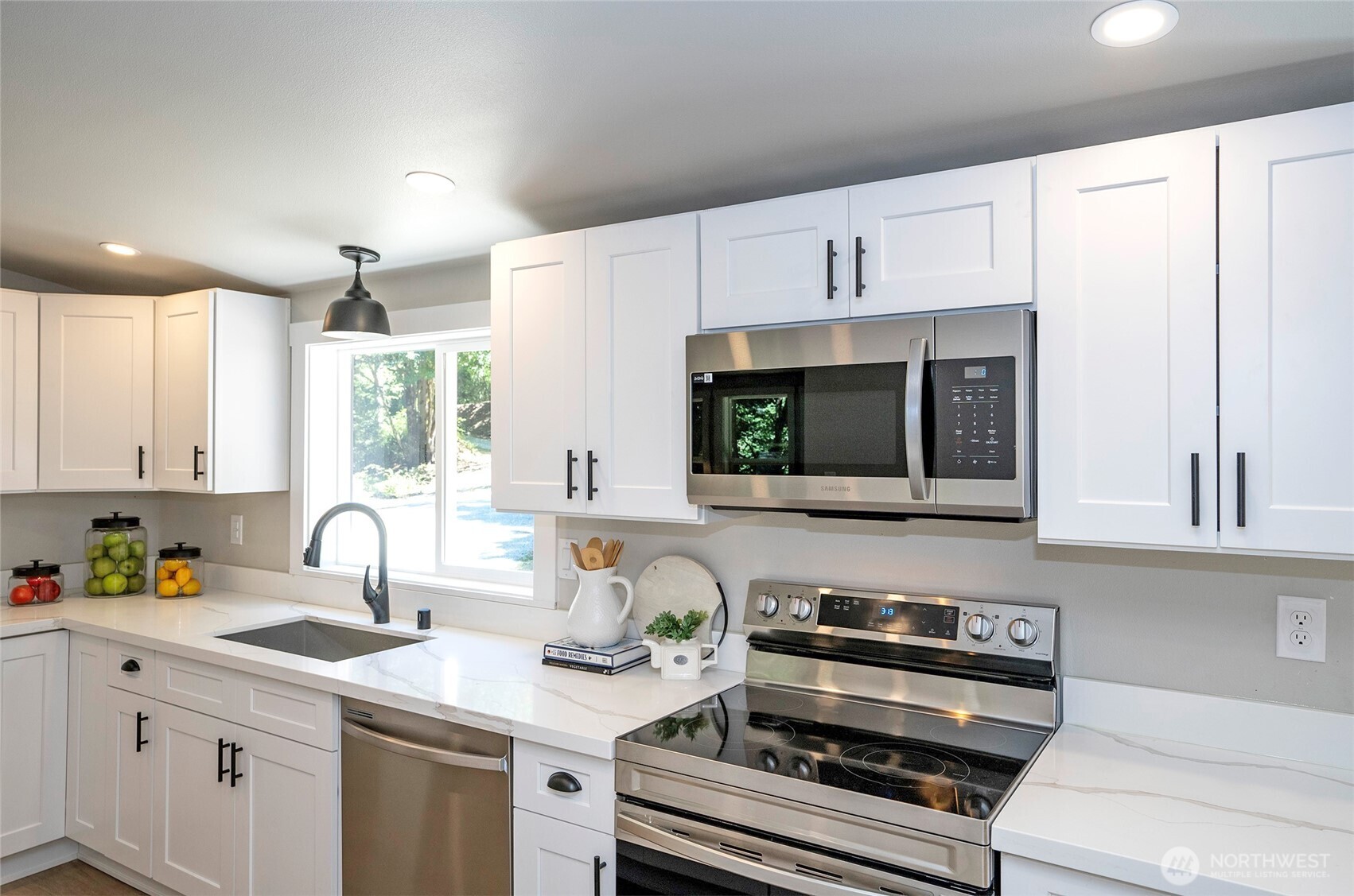 22902 Keating Road Orting, WA 98360 - Photo 11 of 40 a kitchen with appliances a sink cabinets and a window