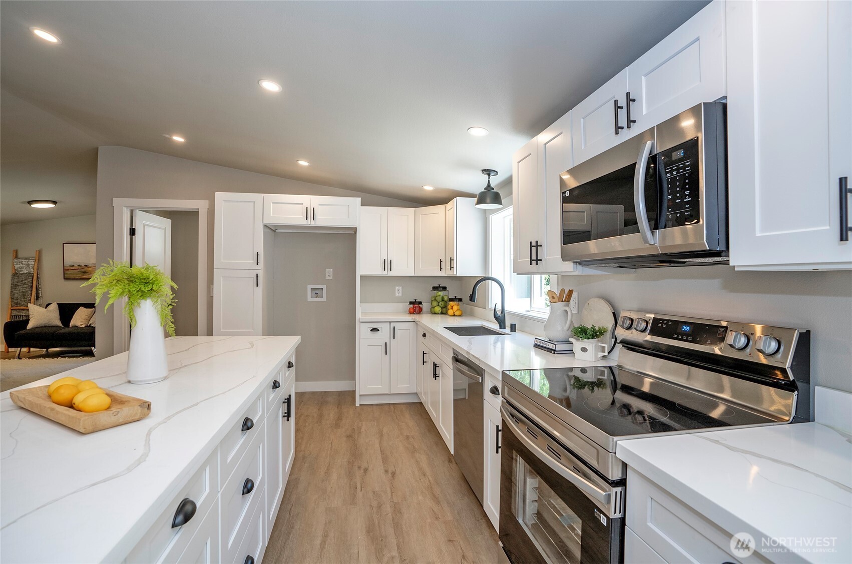 22902 Keating Road Orting, WA 98360 - Photo 12 of 40 a kitchen with stainless steel appliances a stove sink microwave and cabinets
