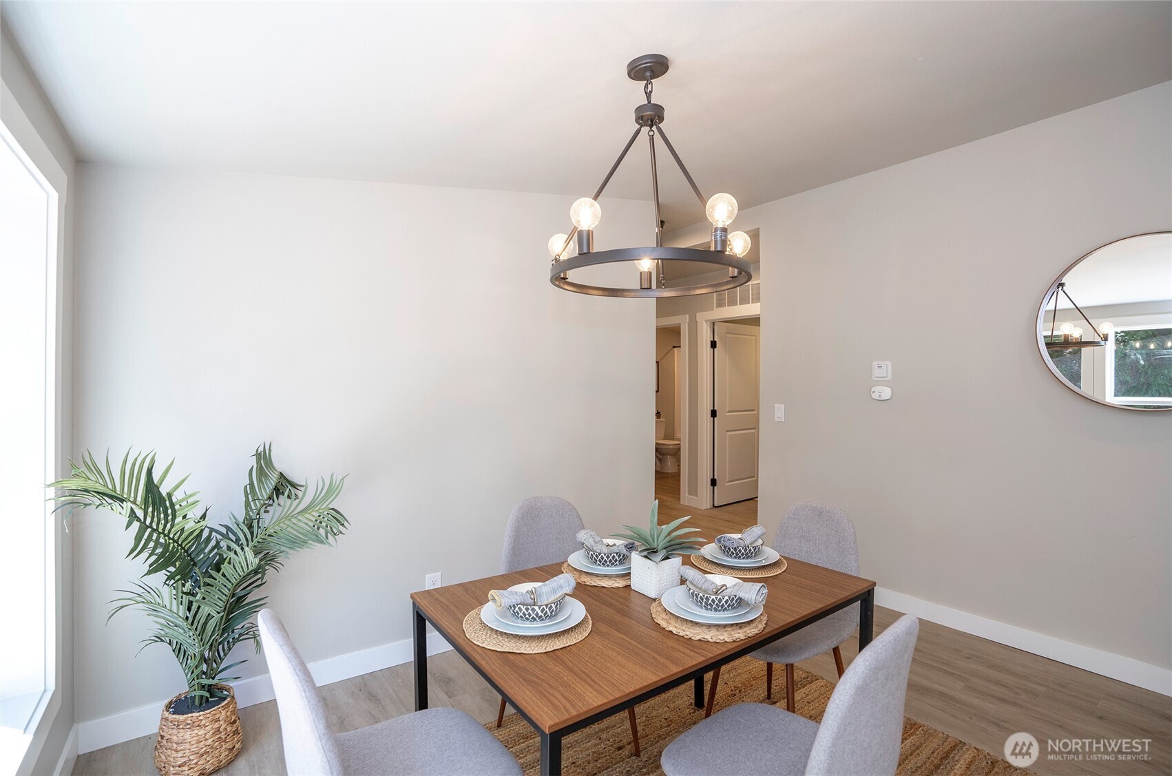 22902 Keating Road Orting, WA 98360 - Photo 15 of 40 a view of a dining room with furniture a chandelier and wooden floor